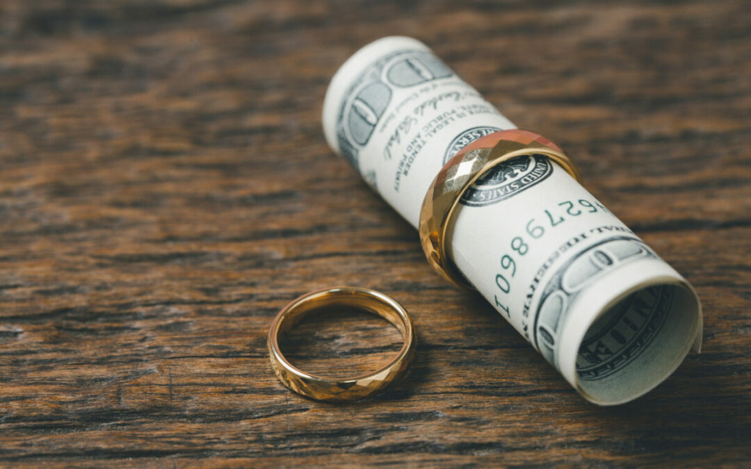 a roll of money sitting on top of a wooden table - Minnesota Spousal Maintenance Statute